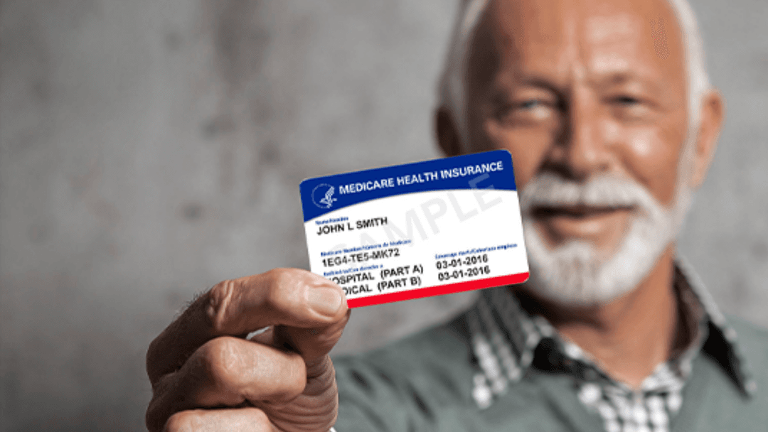 senior man holding up his medicare card stock photo